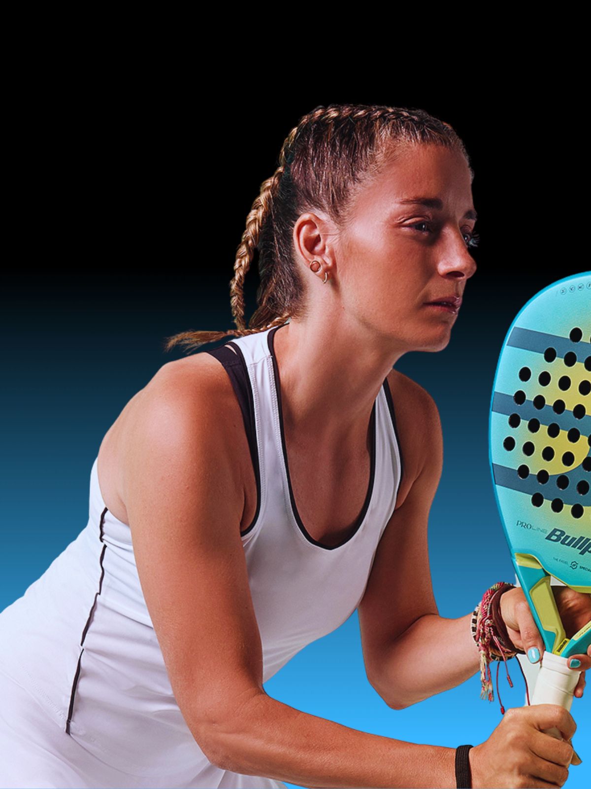 Top Game female padel player focused and ready with Bullpadel racket