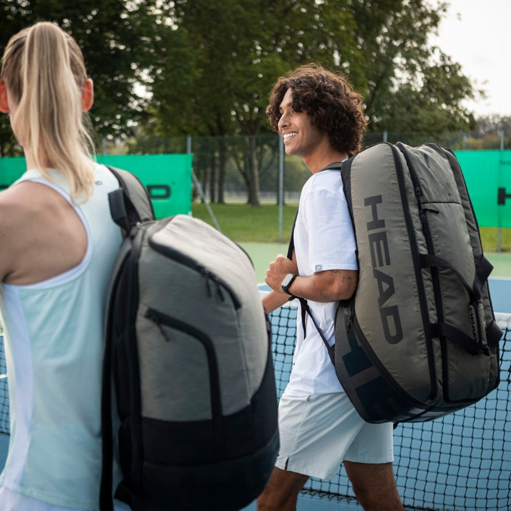 Top Game tennis players walking off court with large HEAD gear bags