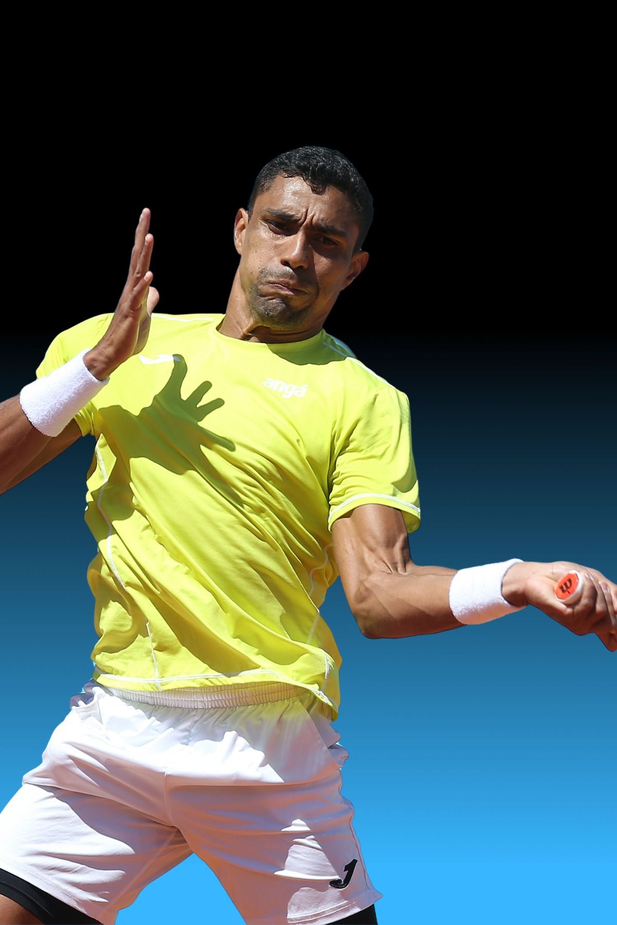 Top Game tennis player in mid-forehand swing wearing yellow shirt and white shorts